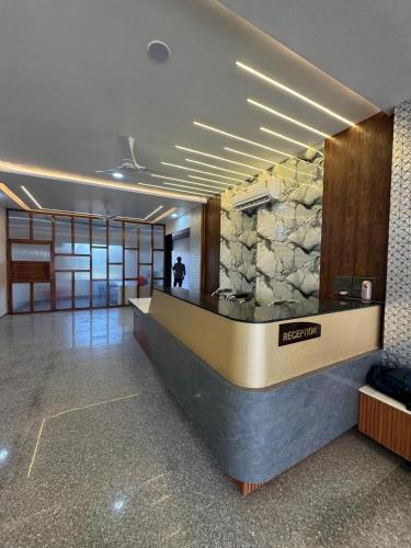 a lobby of a building with a stone wall at The Vizata Hotel in Jaipur