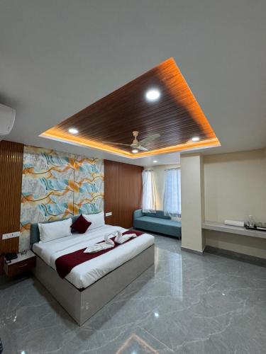 a bedroom with a large bed with a ceiling at The Vizata Hotel in Jaipur