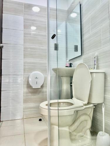 a bathroom with a toilet and a glass shower at Hotel Roma Urabá in Apartadó