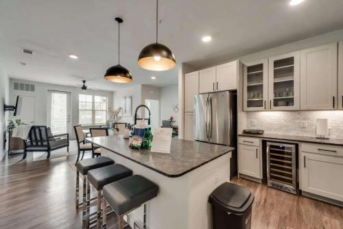 a kitchen with a large island with bar stools at Luxury 3BD Apt Smart Home Pool Grapevine GV202 in Minters Chapel