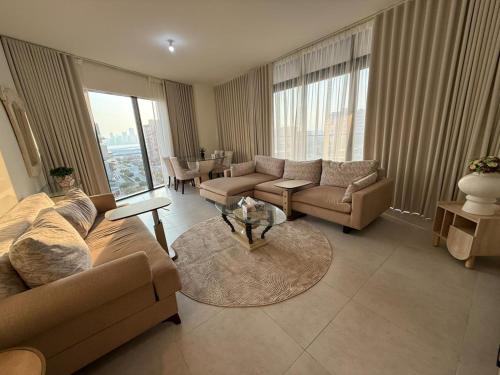 a living room with a couch and a table at Luxury 2-Bedroom APT - Sea Views in Saadiyat Island in Abu Dhabi