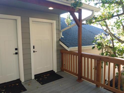 a porch with a white door on a house at Eagles Bluff 1BR Suite of Kalama Oaks Lodge in Kelso
