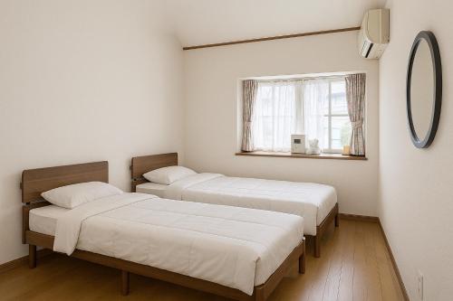 木島平村にあるKijimaBase - Base 1の窓のある部屋にベッドが2つある