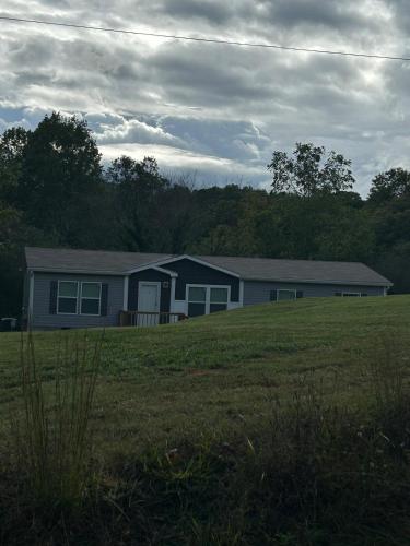 a house in the middle of a field at Panther Creek retreat in Clarkesville