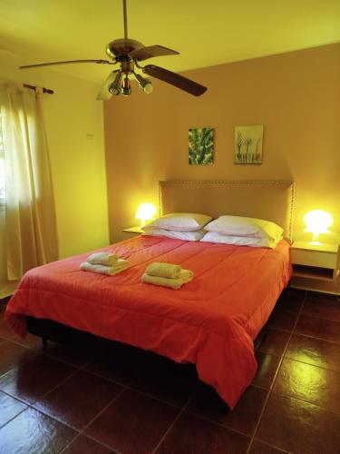 a bedroom with a bed with two towels on it at Cabañas El Ceibo in Villa la Bolsa