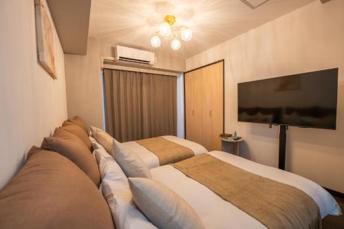 Ένα ή περισσότερα κρεβάτια σε δωμάτιο στο Mell-Theater鈍色の風