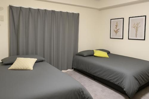 Ένα ή περισσότερα κρεβάτια σε δωμάτιο στο XeroB HOUSE FLOLIA602 フローリア