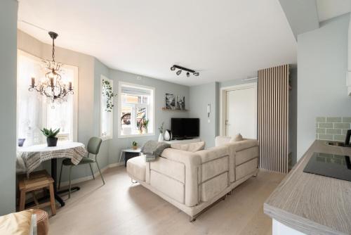 a living room with a white couch and a table at Central apartement in Kristiansund in Kristiansund