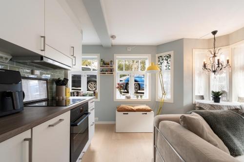 a kitchen and living room with a couch at Central apartement in Kristiansund in Kristiansund