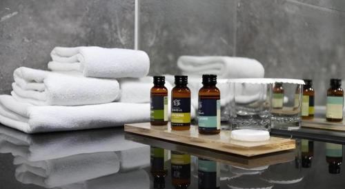 a pile of towels and bottles of alcohol on a table at Ebenezer Hotel in Jeju