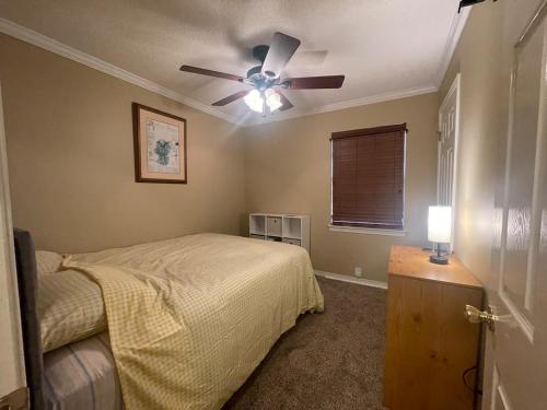 a bedroom with a bed and a ceiling fan at The Yellow Bench House in Long Beach