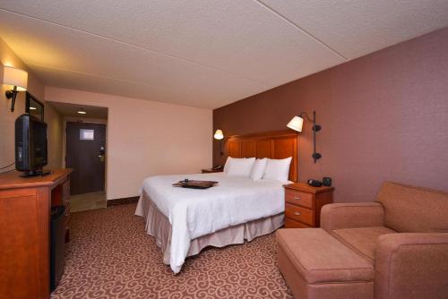 a hotel room with a bed and a couch at McKnight Hotel in Pittsburgh