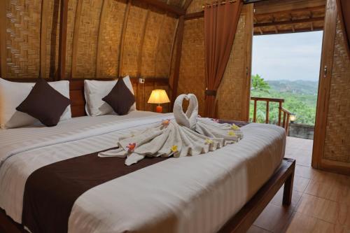 Postel nebo postele na pokoji v ubytování D Sebuluh Bungalow