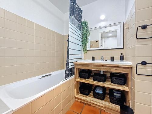 a bathroom with a sink and a bath tub at Ti Mabouya Appartement Saint François in Saint-François