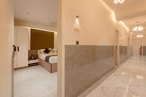 a hotel room with a bed and a bathroom at Legacy Inn, Mysore in Mysore