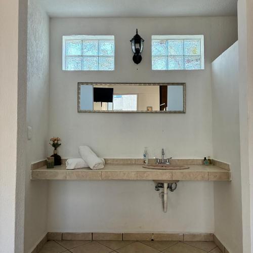 a bathroom with a sink and a mirror at Majaguar Hotel Boutique in Cancún