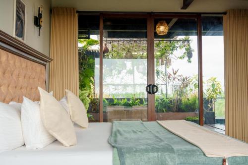 a bedroom with a large bed with white pillows at Penthouse by Grit Villas - Penthouse Apartment with a Private Pool in Negombo