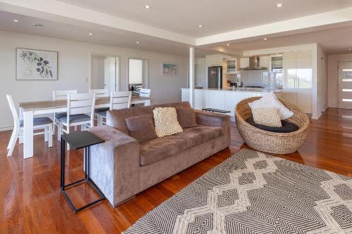 a living room with a couch and a dining room at Blueys Bliss 2 in Blueys Beach