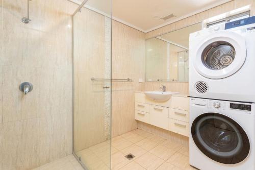 a washing machine in a bathroom with a shower at Blueys Bliss 2 in Blueys Beach