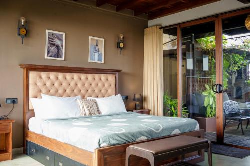 a bedroom with a large bed and a patio at Penthouse by Grit Villas - Penthouse Apartment with a Private Pool in Negombo