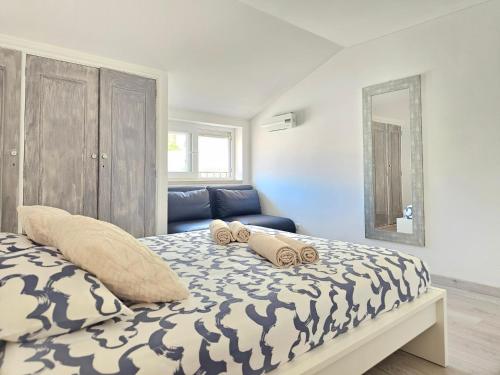 a bedroom with a bed with two pillows on it at Panorama Sun Figueira - 1er ligne Mer in Figueira da Foz