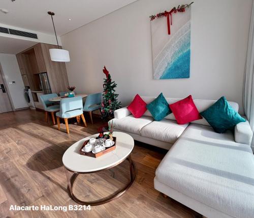 a living room with a couch and a table at A La Carte Ha Long Oceanview Fireworksview Panoramic 2BR2WC suite with balcony in Ha Long