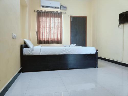 a large bed in a room with a window at GM nest in Coimbatore
