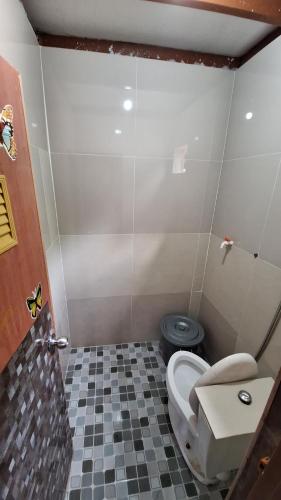 a bathroom with a toilet and a sink at Villa Ainun in Pasirmuncang 1