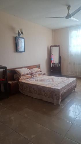 a bedroom with a bed and a mirror on the wall at St Michael View in Moratuwa