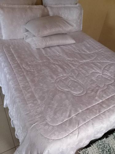a white bed with white sheets and pillows at B vhonani in Polokwane