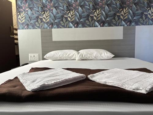 a bed with two towels on it with two pillows at P A Castle in Salem