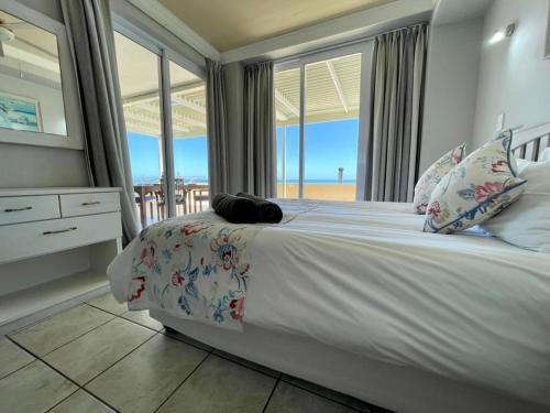 a bedroom with a bed with a view of the ocean at The Sunset Villas in Velddrif