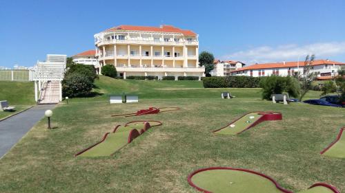 a park with ramps in the grass in front of a building at Résidence Mer & Golf Eugénie in Biarritz