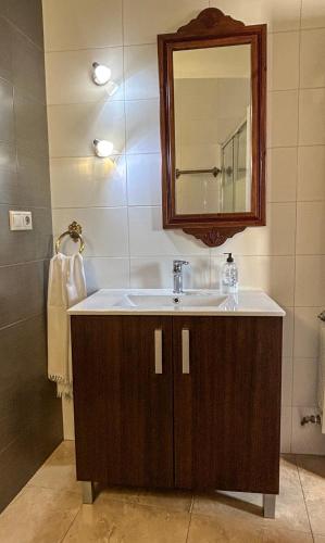 a bathroom with a sink and a mirror at Puerta del Arco in Riópar