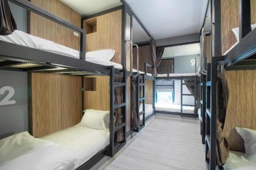 a room with several bunk beds in it at OYO 726 Sookjai Cafe and Hostel in Chiang Mai