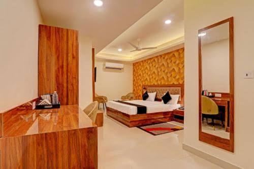 a bedroom with a bed and a desk and a mirror at hotel grand in Zirakpur