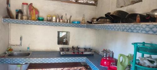 a kitchen with a sink and a counter top at Top hill home stay in Sāma