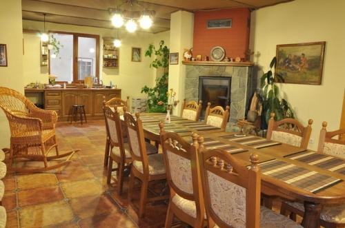 a dining room with a long wooden table and chairs at Hovanka in Yaremche