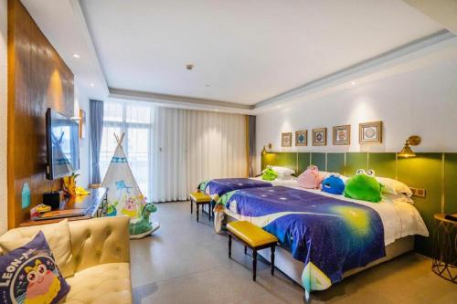 a bedroom with two beds with stuffed animals on them at Qiandao Lake CBS Beer Spa Hotel in Thousand Island Lake