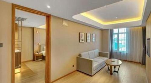 a living room with a couch and a table at Yitel Collection Harbin Railway Station Museum Metro Station in Harbin