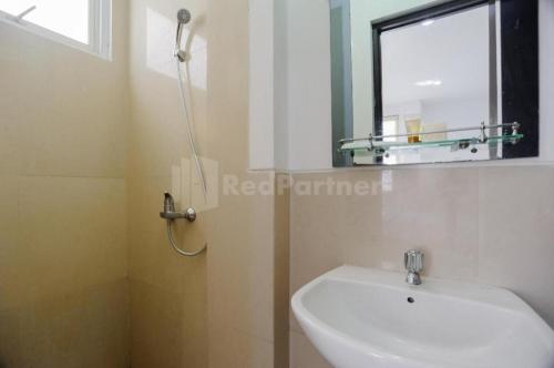 a bathroom with a white sink and a mirror at Green Residence 25 Syariah Karawaci RedPartner in Binong