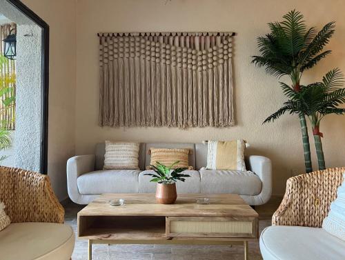 a living room with a couch and a table at Exclusive apt with private rooftop & amazing views in Cancún