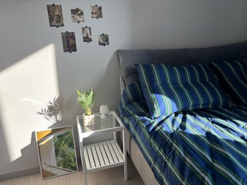 a room with a couch and a table with pictures on the wall at Indeogwon stay 27 in Mabun-ni