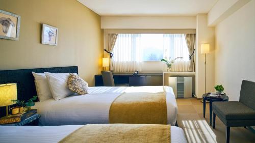 Ένα ή περισσότερα κρεβάτια σε δωμάτιο στο アルソア女神の森 美ウェルネスリトリート