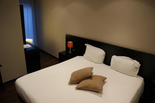 Tempat tidur dalam kamar di Hotel Aniene