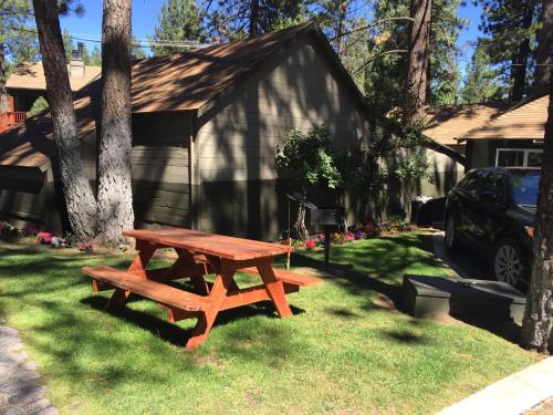 a picnic table in the grass in front of a house at Big Bear Frontier in Big Bear Lake