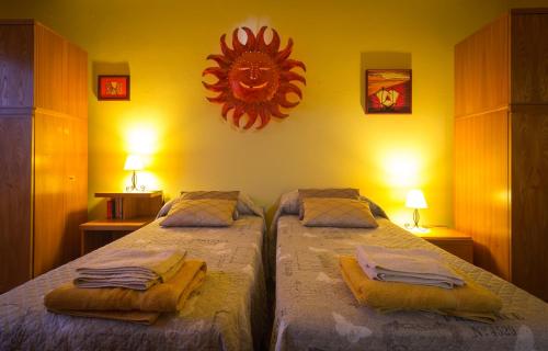 a bedroom with two beds with towels on them at Su Connotu in Sestu