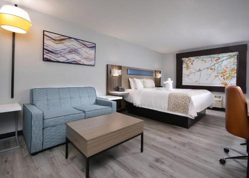 a hotel room with a bed and a chair at Brookstone Lodge near Biltmore Village, an Ascend Collection Hotel in Asheville