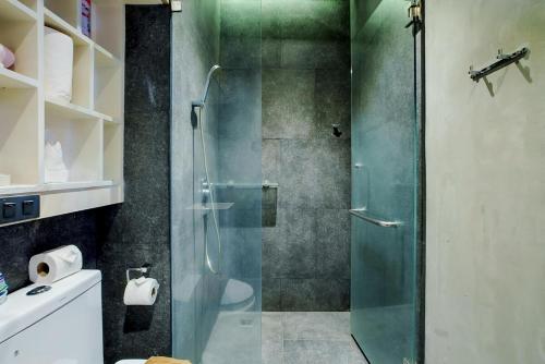 a bathroom with a shower with a glass door at 405 Relife , 5 Minutes Walk To Nai Harn Beach in Rawai Beach