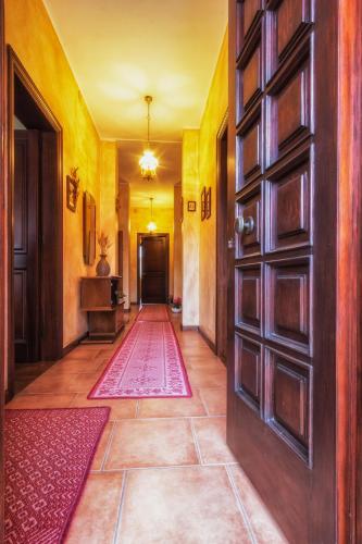 a hallway with a door and a rug at Su Connotu in Sestu